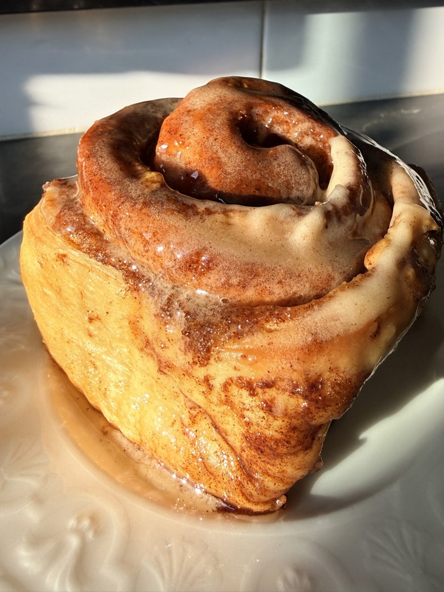 A glazed Baked by Yoga cinnamon roll